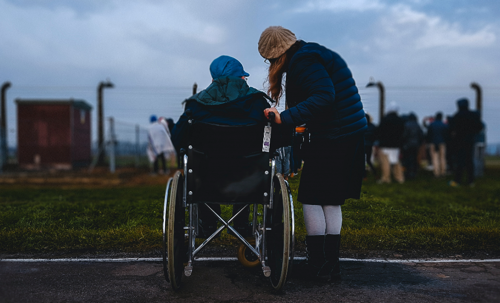 Person in wheelchair and person standing